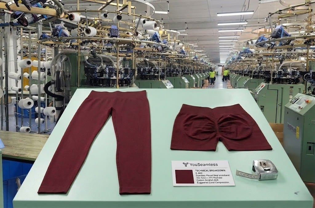 Custom private label seamless leggings on an inspection table at a facility of professional yoga pants manufacturers.