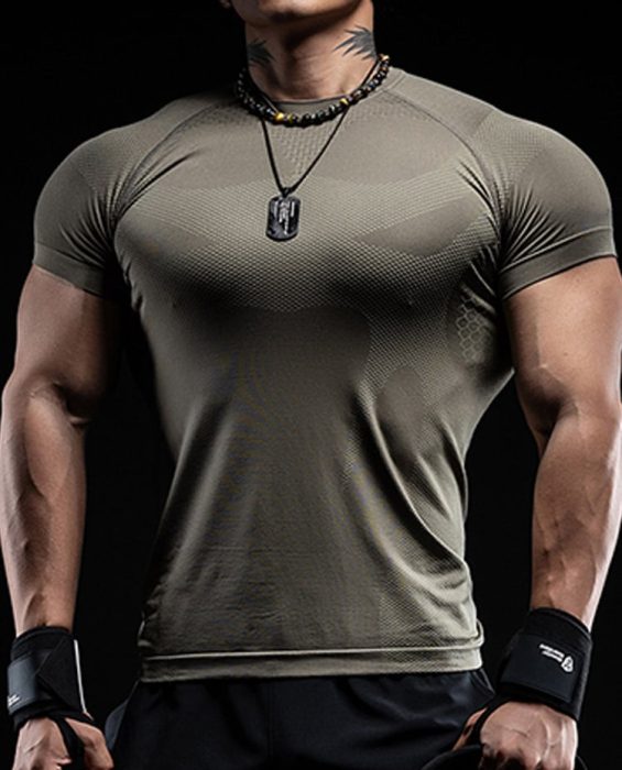 Muscular male model wearing an olive-green high-performance seamless compression gym shirt for athletic training.